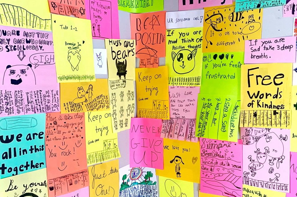 color paper with positive messages covering corner of wall