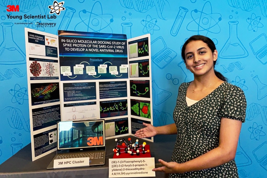 girl with black and white shirt standing on the right Poster board full of graphics and text