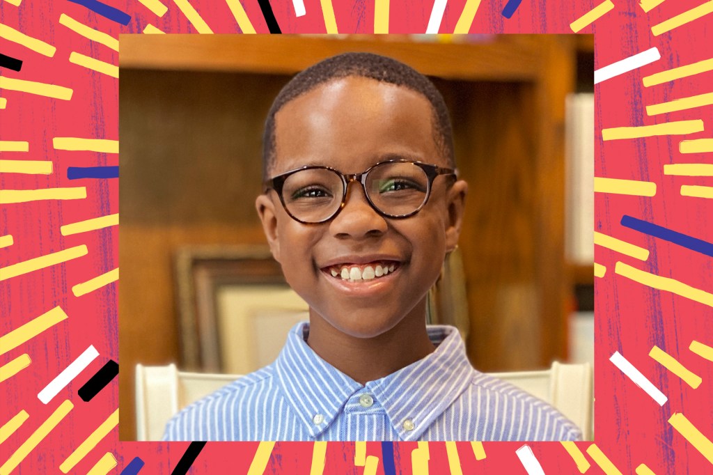 close up of boy with glasses smiling