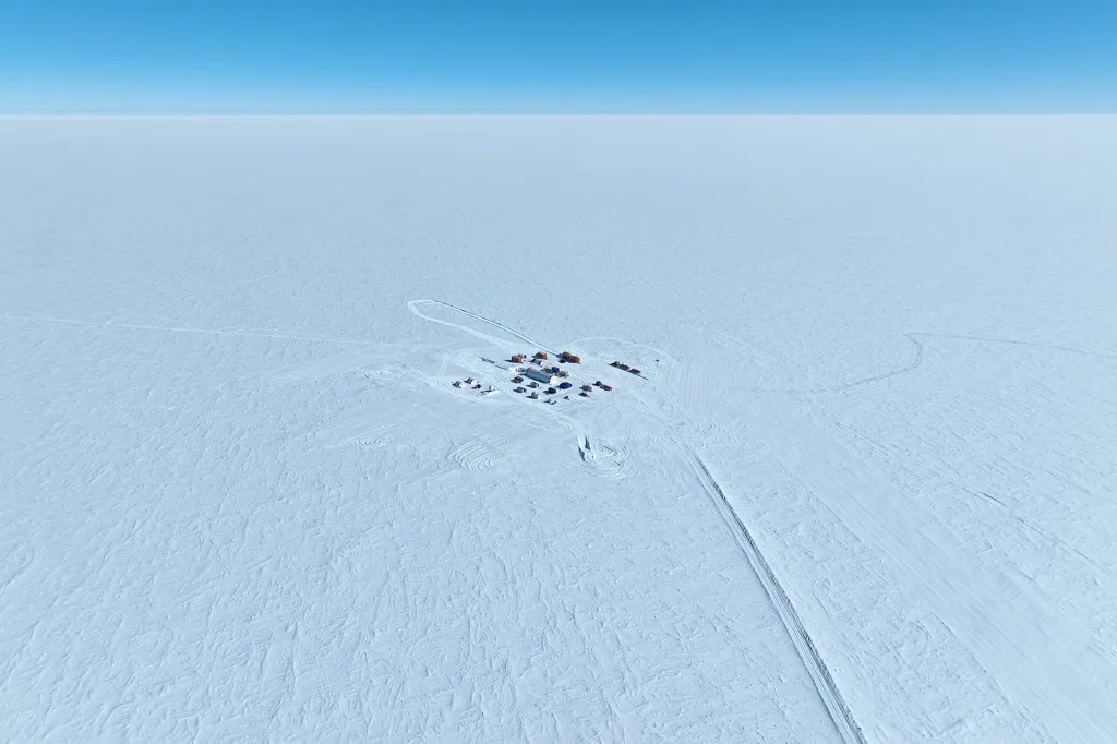 A tiny polar research camp on a huge white ice sheet.