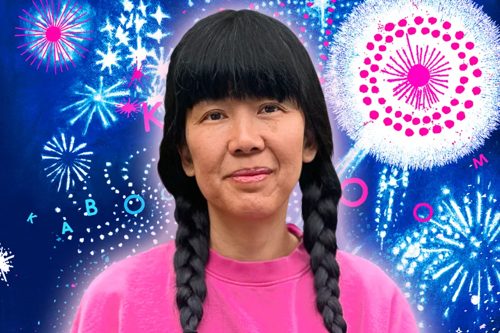 A woman with braided hair smiles in front of a bright background filled with colorful fireworks.