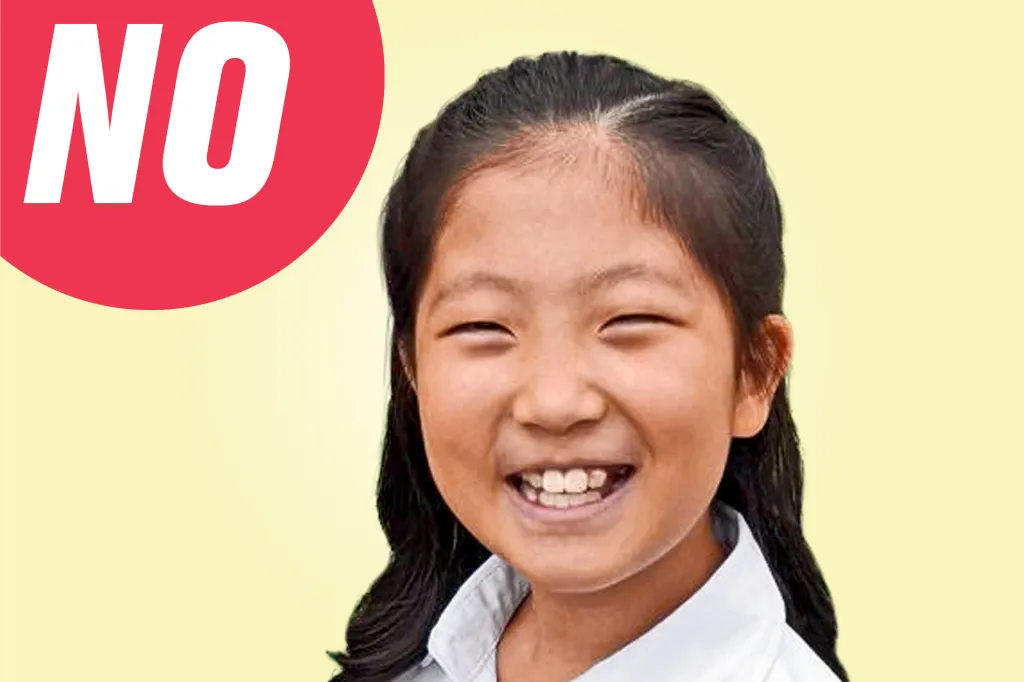 A smiling girl looks at the camera, with a red speech bubble that says “NO.”