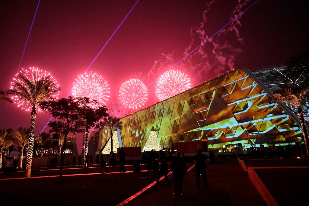 Fireworks light up the night sky above a museum.