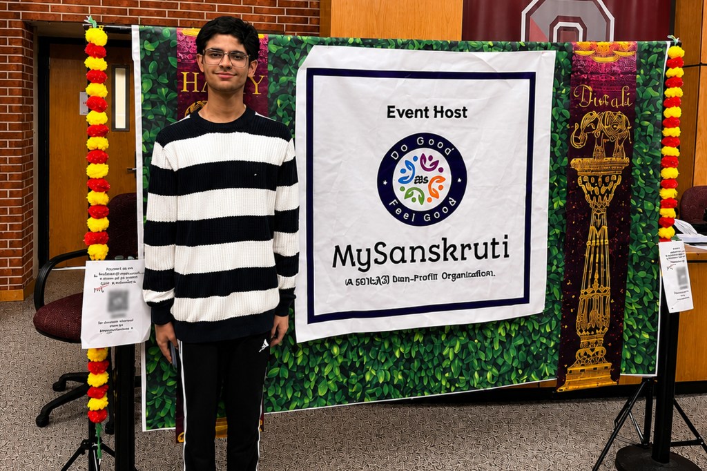 A teenager stands at a decorated display promoting their non-profit organization